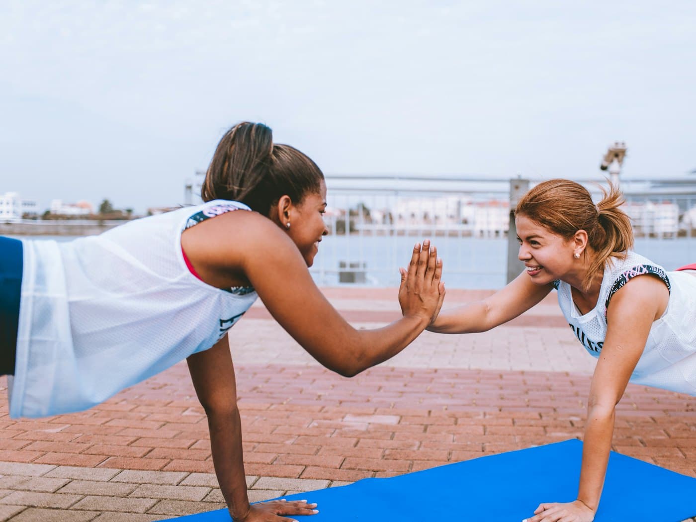 Two colleagues training together using bodyweight only