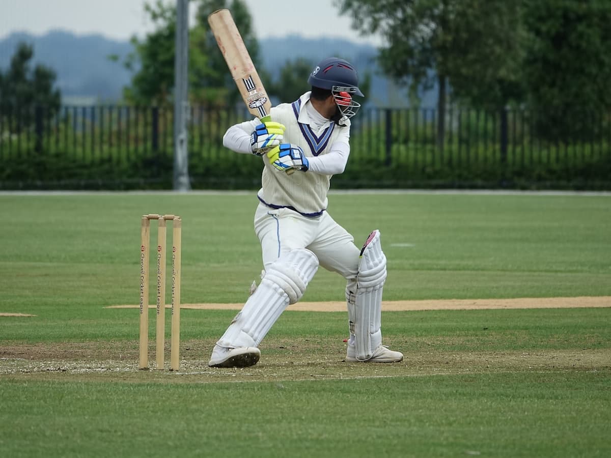 A batter playing a shot during a cricket match
